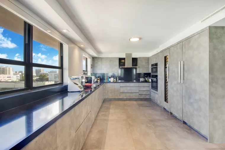 The kitchen: a stone-topped run the length of the room, with integrated joinery.